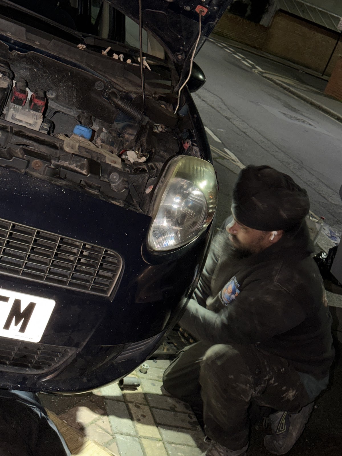 Mechanic working underneath a car on the ramp at Mr Singh Mobile Mechanic